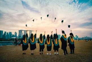 people throwing hats on air by Pang Yuhao courtesy of Unsplash.